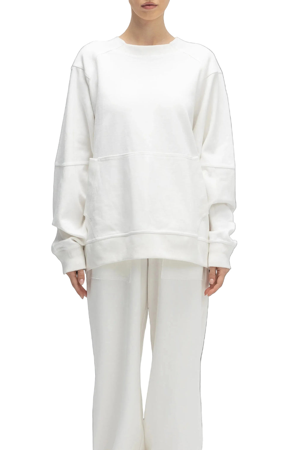 Person wearing a white sweatshirt and pants on a white background